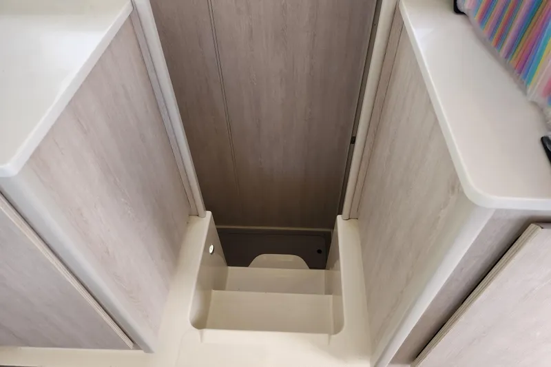 Cara Lynn Yacht Photos Pics Staircase inside 2015 Leopard 44 catamaran with light wood finish.