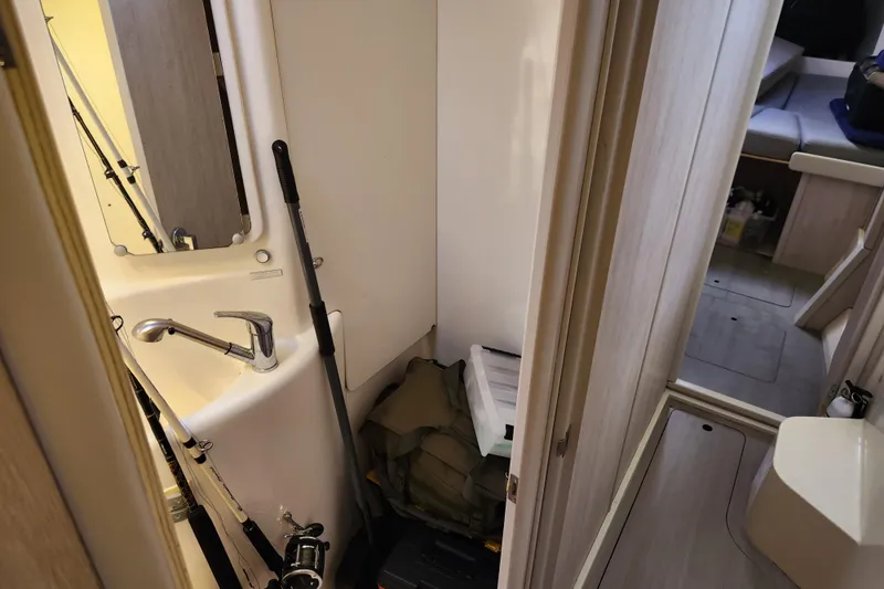 Cara Lynn Yacht Photos Pics Compact bathroom in a 2015 Leopard 44 yacht with fishing gear and storage.