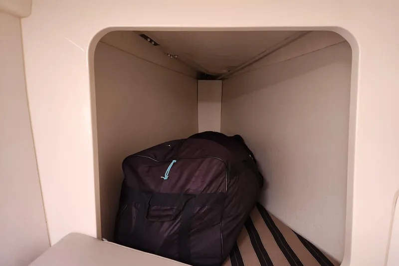 Cara Lynn Yacht Photos Pics Storage compartment in a 2015 Leopard 44 yacht with a large black bag.