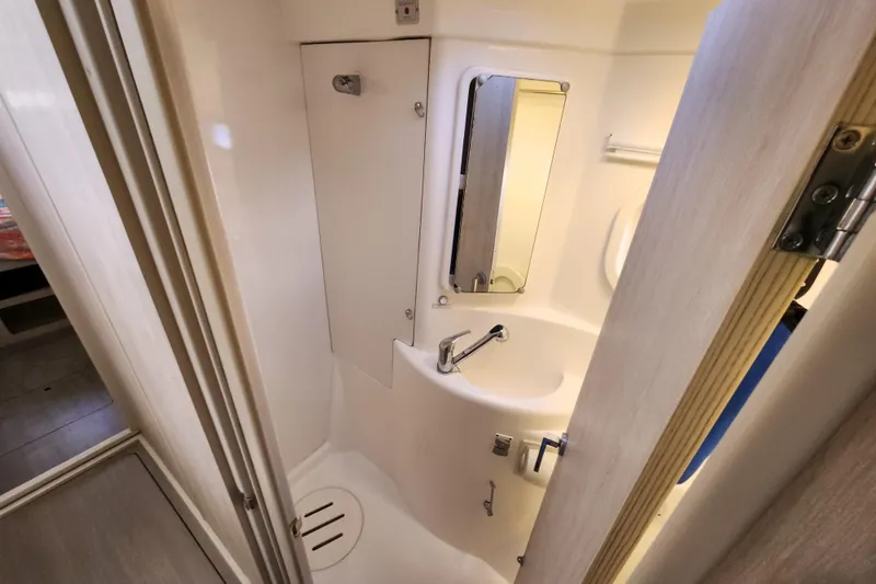 Cara Lynn Yacht Photos Pics Compact bathroom in a 2015 Leopard 44 yacht, featuring a sink and mirror.