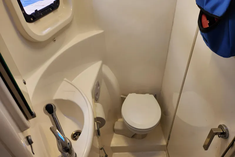 Cara Lynn Yacht Photos Pics Compact bathroom in a 2015 Leopard 44 yacht with toilet and sink.