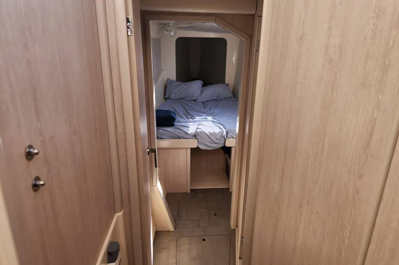 Cara Lynn Yacht Photos Pics Cozy cabin interior of 2015 Leopard 44 yacht with neatly made bed.