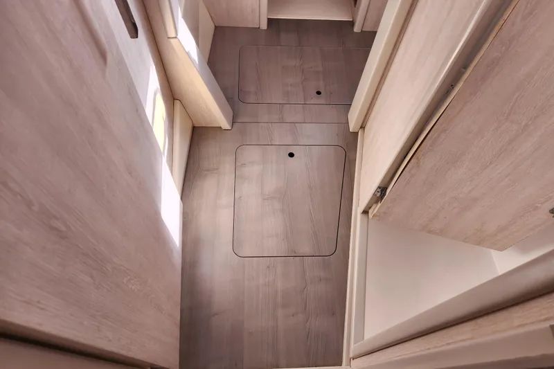 Cara Lynn Yacht Photos Pics Interior view of 2015 Leopard 44 yacht with wooden flooring and storage compartments.