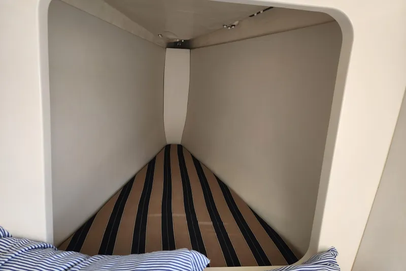 Cara Lynn Yacht Photos Pics Cozy cabin interior of 2015 Leopard 44 yacht with striped bedding.