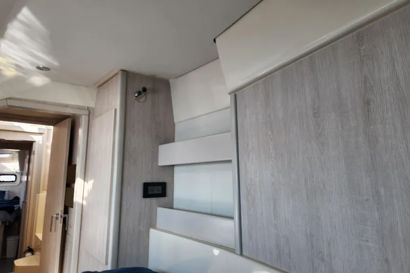 Cara Lynn Yacht Photos Pics Interior of a 2015 Leopard 44 yacht with modern wood paneling and lighting.