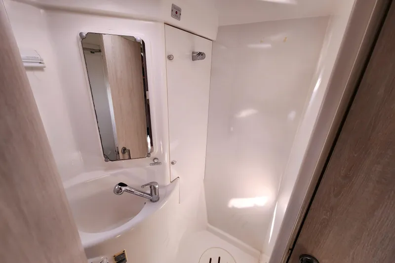 Cara Lynn Yacht Photos Pics Compact bathroom in a 2015 Leopard 44 yacht, featuring a sink and mirror.