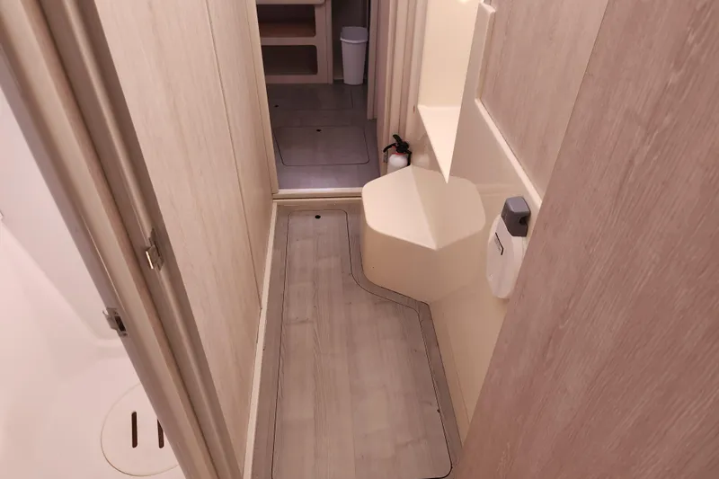 Cara Lynn Yacht Photos Pics Narrow hallway in 2015 Leopard 44 yacht with wooden flooring and beige walls.