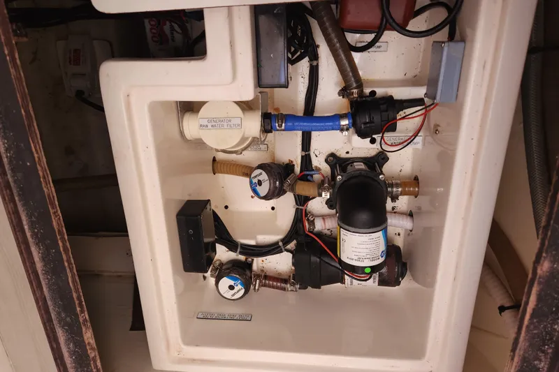 Cara Lynn Yacht Photos Pics Engine compartment of a 2015 Leopard 44, showcasing water filtration and pump system.