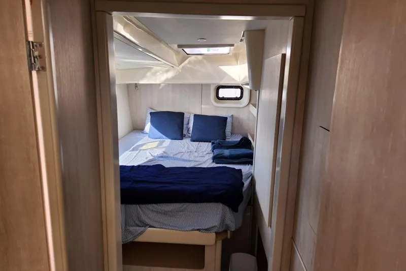 Cara Lynn Yacht Photos Pics Cozy bedroom in 2015 Leopard 44 yacht with blue bedding and natural light.