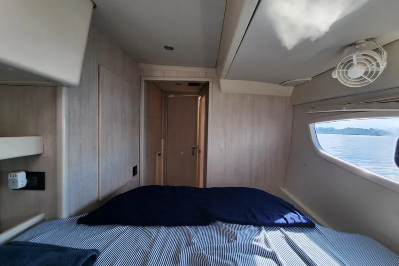 Cara Lynn Yacht Photos Pics Cozy cabin interior of 2015 Leopard 44 yacht with ocean view through window.