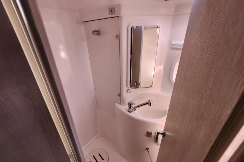 Cara Lynn Yacht Photos Pics Compact bathroom in a 2015 Leopard 44 yacht, featuring a sink and mirror.