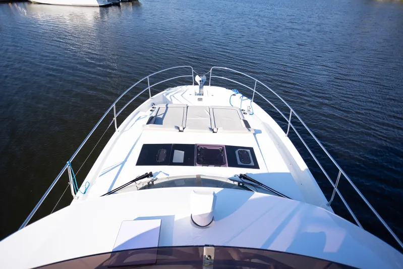 Samadhi Yacht Photos Pics 2024 Jeanneau NC 1295 Fly yacht deck view on calm water.