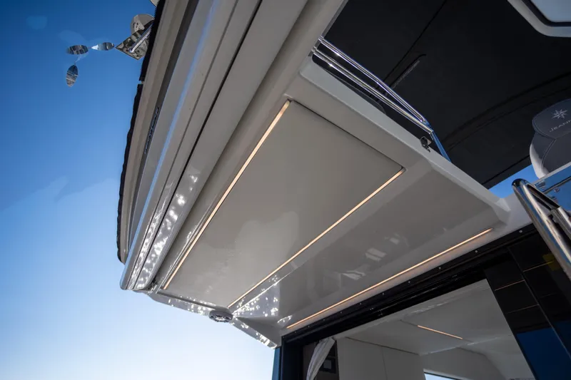 Samadhi Yacht Photos Pics 2024 Jeanneau NC 1295 Fly yacht, showcasing sleek design and modern lighting under a clear sky.