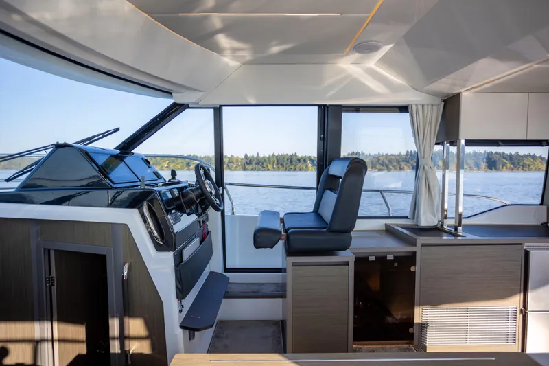 Samadhi Yacht Photos Pics Interior of 2024 Jeanneau NC 1295 Fly yacht with modern helm and panoramic windows.