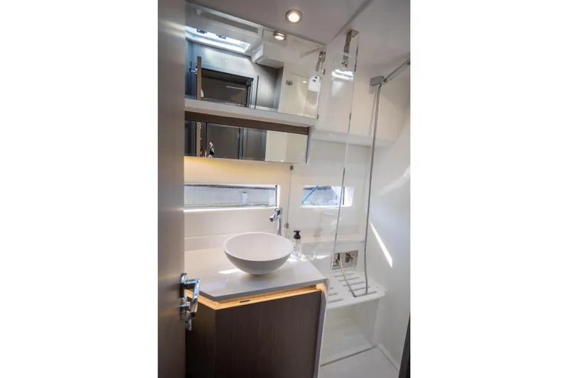 Samadhi Yacht Photos Pics Modern bathroom interior of 2024 Jeanneau NC 1295 Fly yacht, featuring sleek design and fixtures.