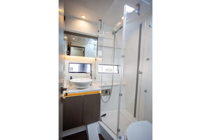 Samadhi Yacht Photos Pics Luxurious bathroom in 2024 Jeanneau NC 1295 Fly yacht with modern fixtures and elegant design.