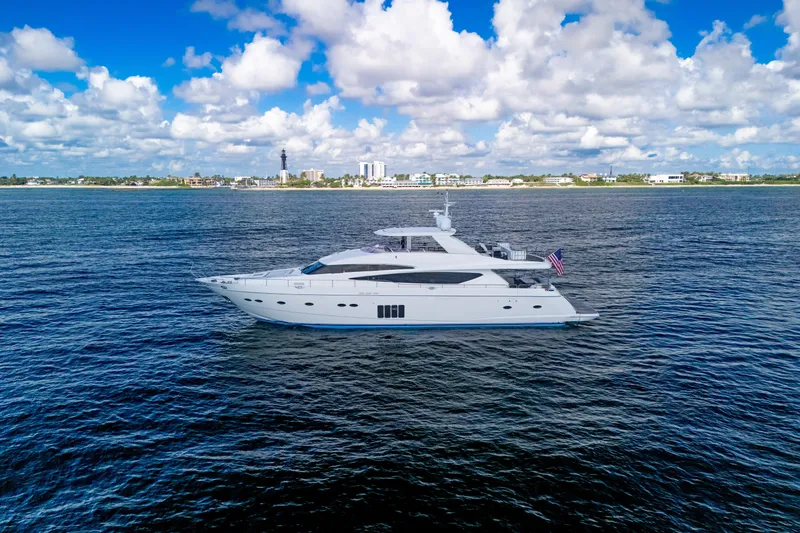 Oasis Yacht Photos Pics Luxurious 2010 Princess 95 Motor Yacht cruising on open water under a vibrant sky.