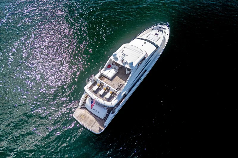 Oasis Yacht Photos Pics Aerial view of 2010 Princess 95 Motor Yacht on shimmering water.
