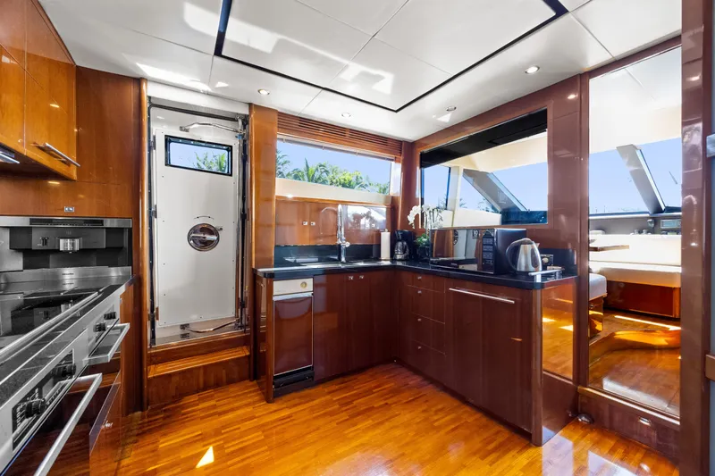 Oasis Yacht Photos Pics Luxurious kitchen interior of 2010 Princess 95 Motor Yacht with modern appliances and sleek design.