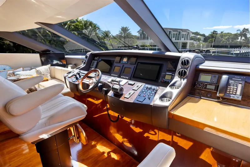 Oasis Yacht Photos Pics Luxurious helm of 2010 Princess 95 Motor Yacht with modern navigation equipment and plush seating.