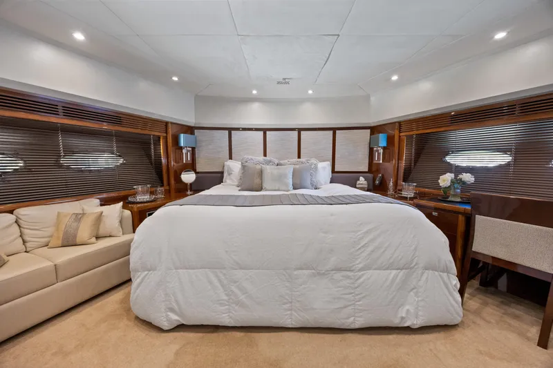 Oasis Yacht Photos Pics Luxurious bedroom interior of 2010 Princess 95 Motor Yacht with elegant decor and plush bedding.