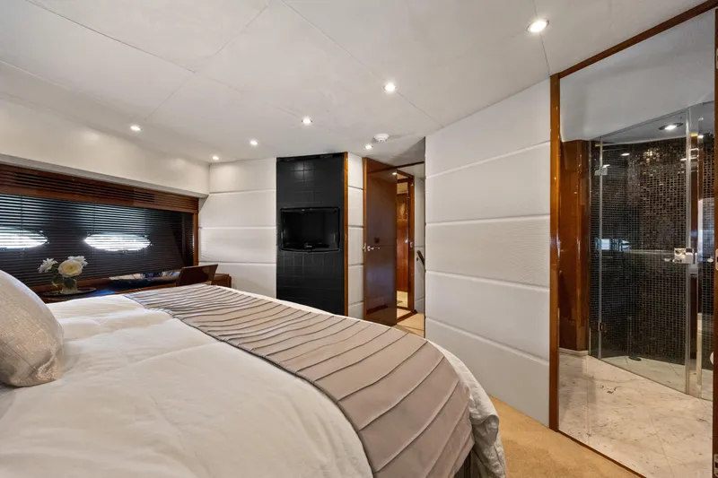 Oasis Yacht Photos Pics Luxurious bedroom interior of 2010 Princess 95 Motor Yacht with modern decor and ensuite bathroom.