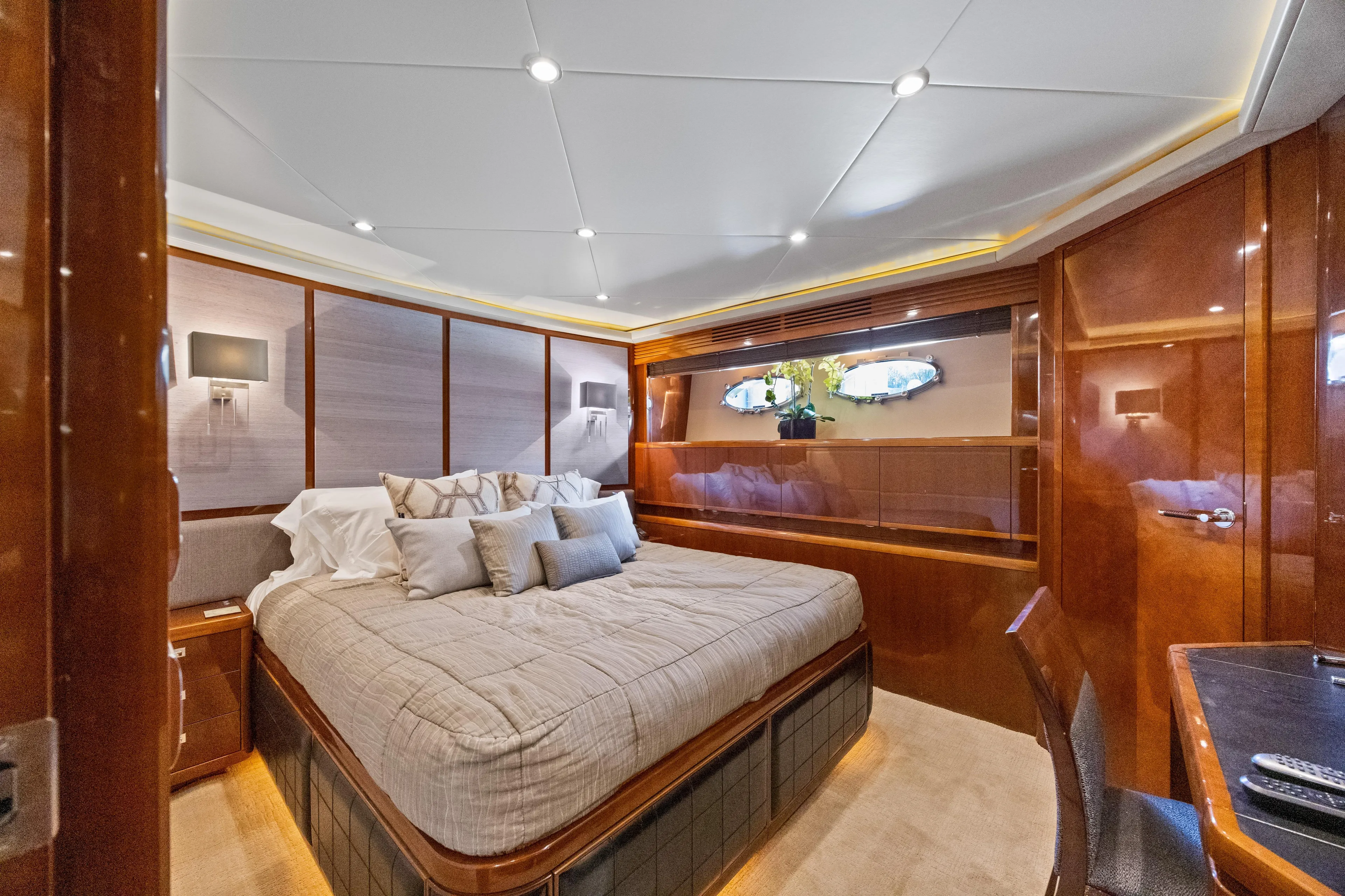 Oasis Yacht Photos Pics Luxurious bedroom interior of 2010 Princess 95 Motor Yacht with elegant wood paneling.