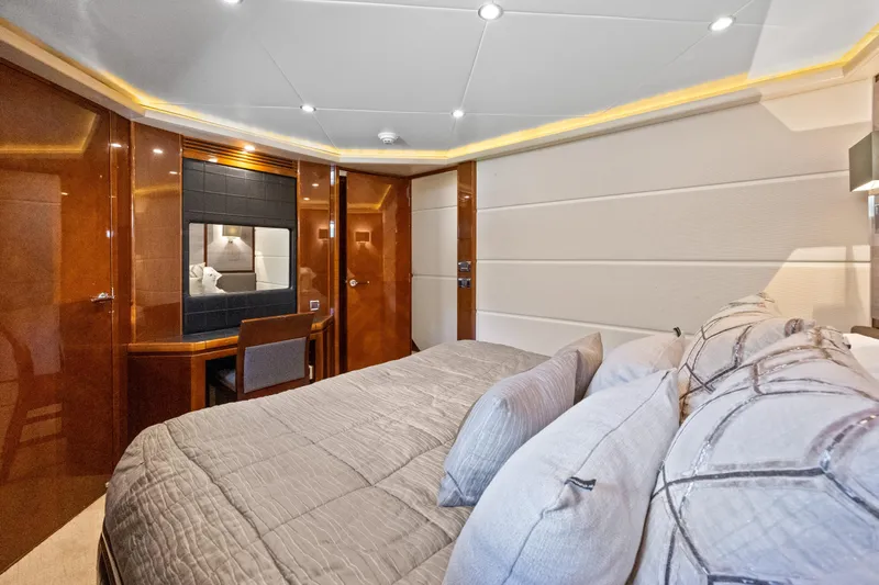 Oasis Yacht Photos Pics Luxurious bedroom interior of 2010 Princess 95 Motor Yacht with elegant wood finishes.