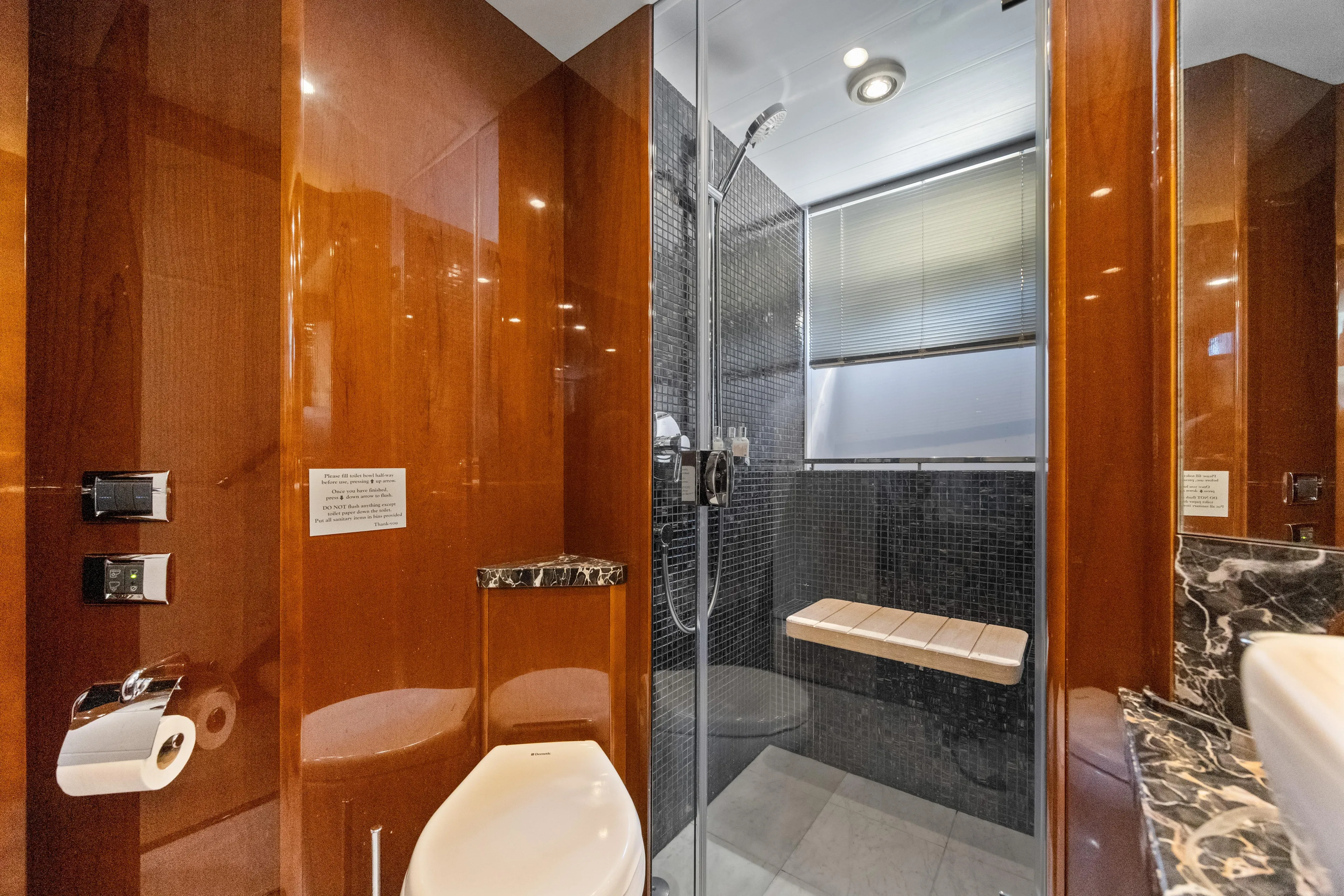 Oasis Yacht Photos Pics Luxurious bathroom on 2010 Princess 95 Motor Yacht with sleek wood paneling and modern shower.