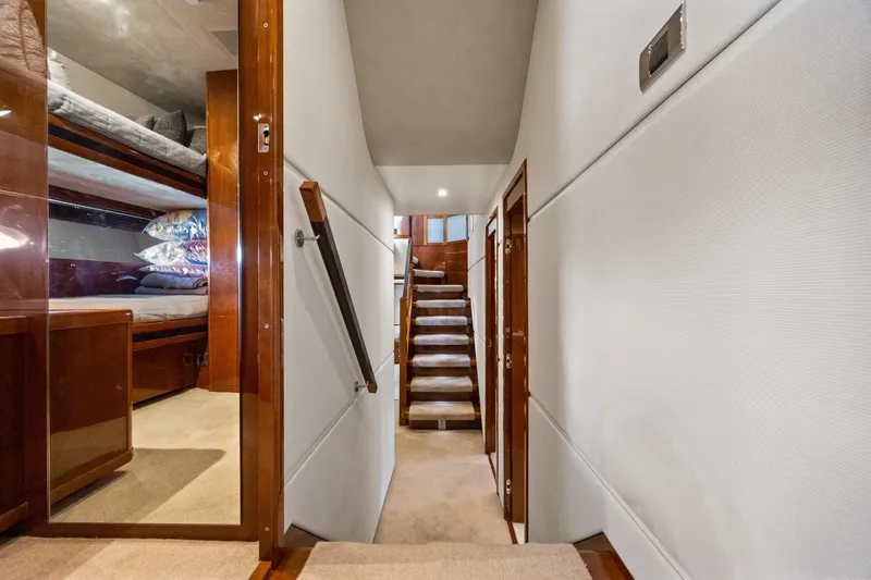 Oasis Yacht Photos Pics Luxurious interior hallway of 2010 Princess 95 Motor Yacht with wooden finishes.
