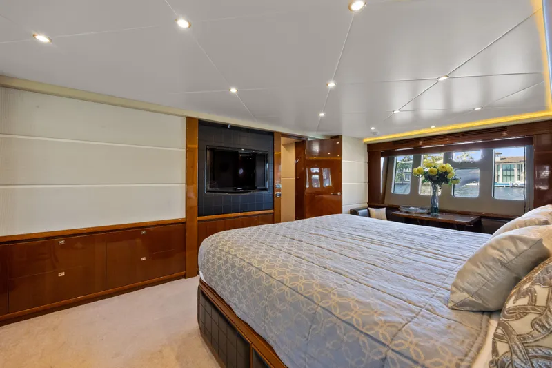 Oasis Yacht Photos Pics Luxurious bedroom interior of 2010 Princess 95 Motor Yacht with elegant decor and large windows.