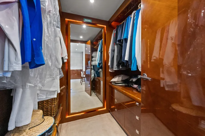 Oasis Yacht Photos Pics Luxurious walk-in closet on 2010 Princess 95 Motor Yacht with elegant wood finish.