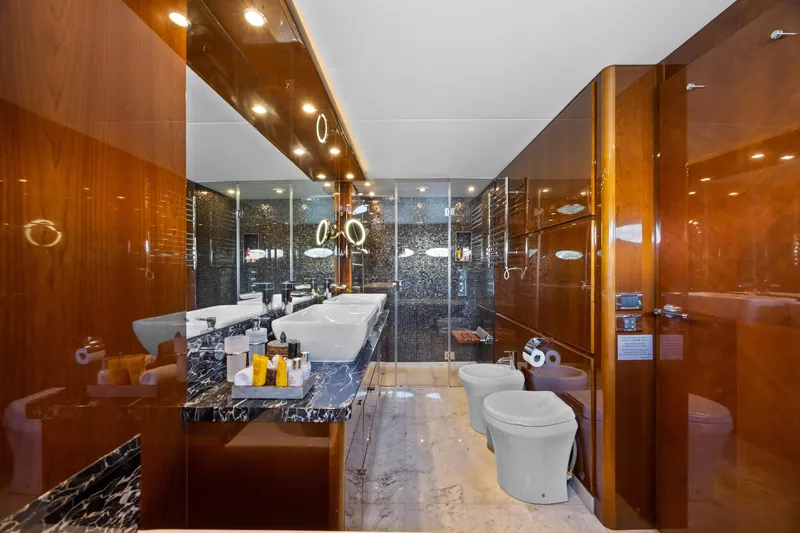 Oasis Yacht Photos Pics Luxurious bathroom on 2010 Princess 95 Motor Yacht with elegant wood and marble finishes.