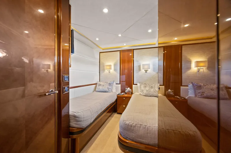 Oasis Yacht Photos Pics Luxurious twin cabin interior of 2010 Princess 95 Motor Yacht, featuring elegant wood finishes.