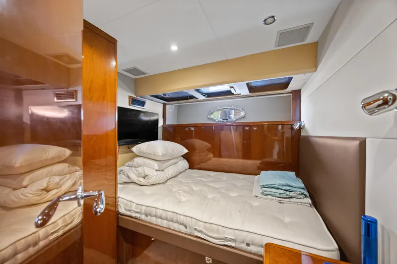 Oasis Yacht Photos Pics Luxurious cabin interior of 2010 Princess 95 Motor Yacht with plush bedding and wood finishes.