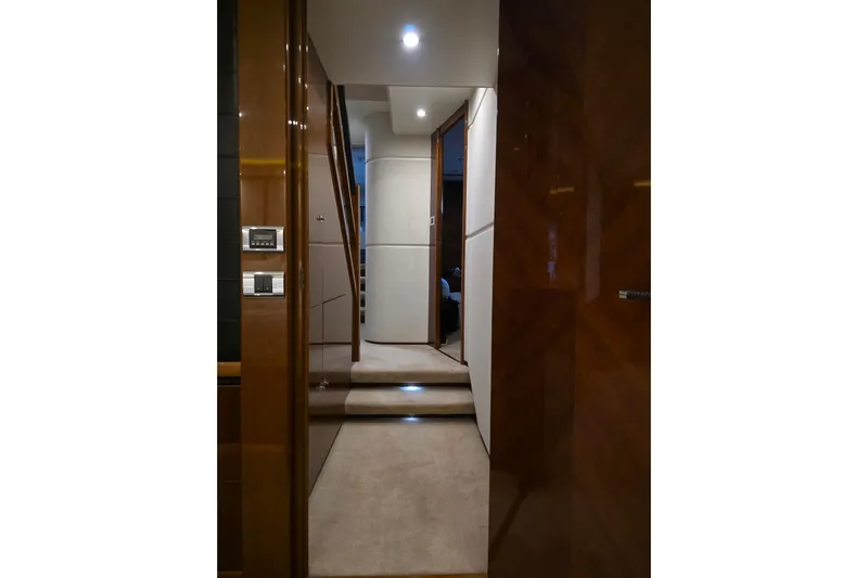 Oasis Yacht Photos Pics Interior hallway of 2010 Princess 95 Motor Yacht with modern lighting and wood paneling.
