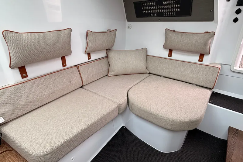  Yacht Photos Pics Interior seating of 2021 Axopar 37 XC Cross Cabin with beige cushions and wall panel.