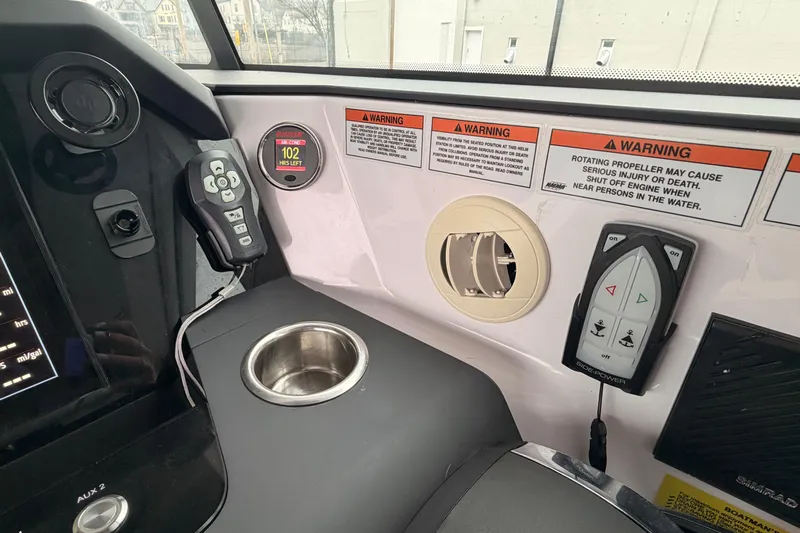  Yacht Photos Pics Control panel of 2021 Axopar 37 XC Cross Cabin with warning labels and cup holder.