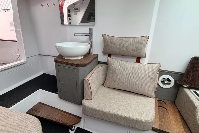  Yacht Photos Pics Interior of 2021 Axopar 37 XC Cross Cabin with modern sink and cushioned seating.