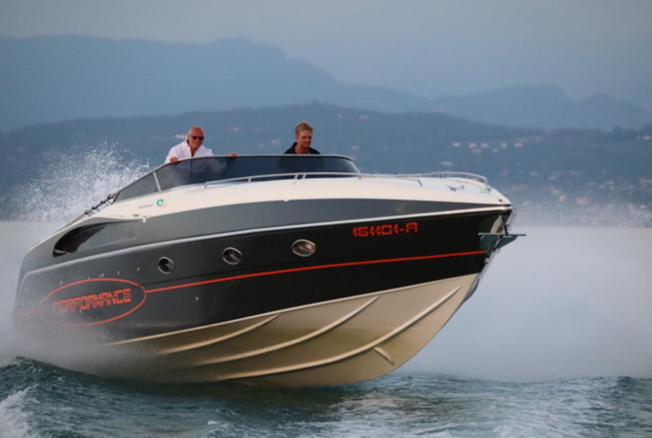 Performance 1201 speedboat cruising on water, 2022 model, with two people onboard.
