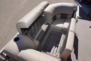 2024 Sun Tracker Party Barge 20 DLX seating with storage compartment open.
