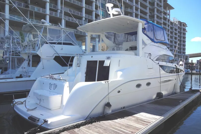 Lit Up Yacht Photos Pics 2007 Meridian 459 yacht docked at marina, surrounded by other yachts at the docks for sale by Robbins Flynn.