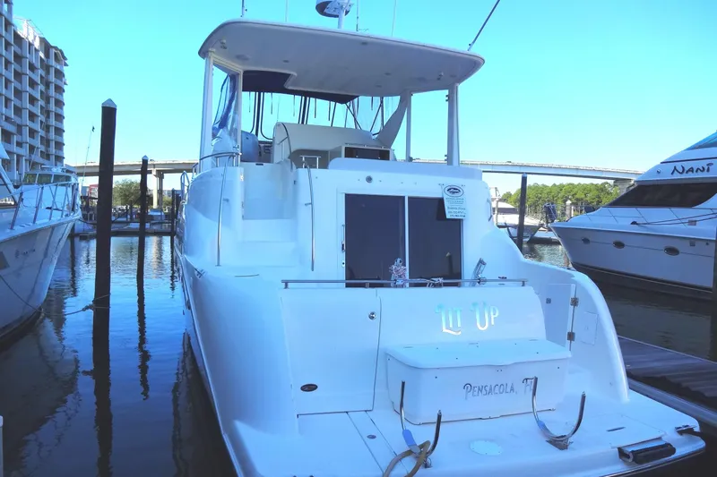 Lit Up Yacht Photos Pics 2007 Meridian 459 yacht docked at marina, rear view with clear sky.