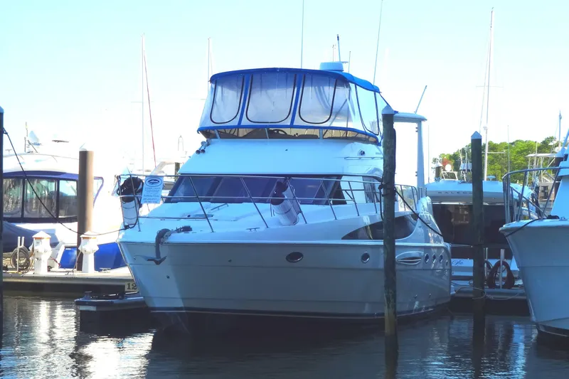 Lit Up Yacht Photos Pics 2007 Meridian 459 yacht docked at marina, featuring sleek design and spacious upper deck.