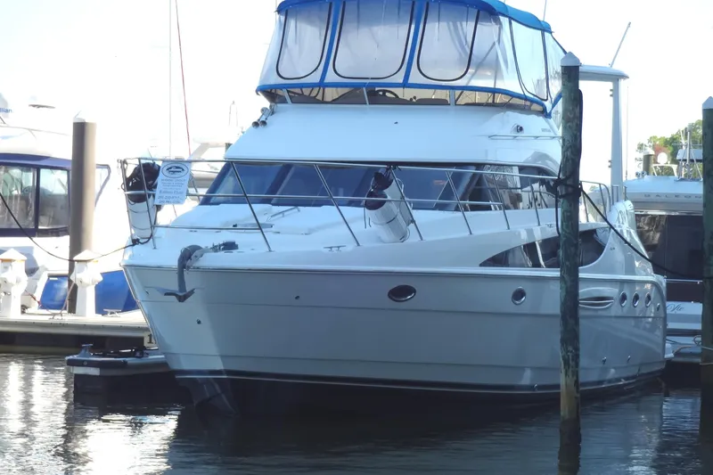 Lit Up Yacht Photos Pics 2007 Meridian 459 yacht docked at marina, featuring sleek design and blue canopy.