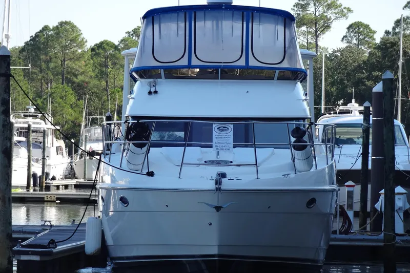 Lit Up Yacht Photos Pics 2007 Meridian 459 yacht docked at marina, surrounded by trees and other boats.
