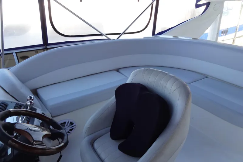 Lit Up Yacht Photos Pics Interior of a 2007 Meridian 459 yacht, featuring a steering wheel and cushioned seating.