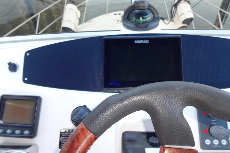 Lit Up Yacht Photos Pics 2007 Meridian 459 yacht helm with Simrad display and steering wheel.