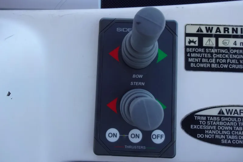 Lit Up Yacht Photos Pics Control panel of a 2007 Meridian 459 boat with thruster controls and warning labels.