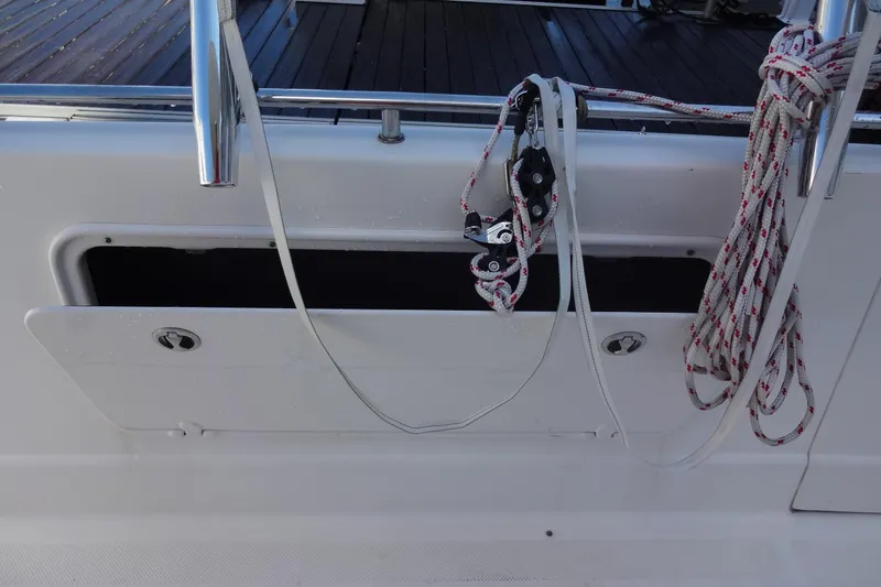 Lit Up Yacht Photos Pics 2007 Meridian 459 yacht deck with ropes and open storage compartment.